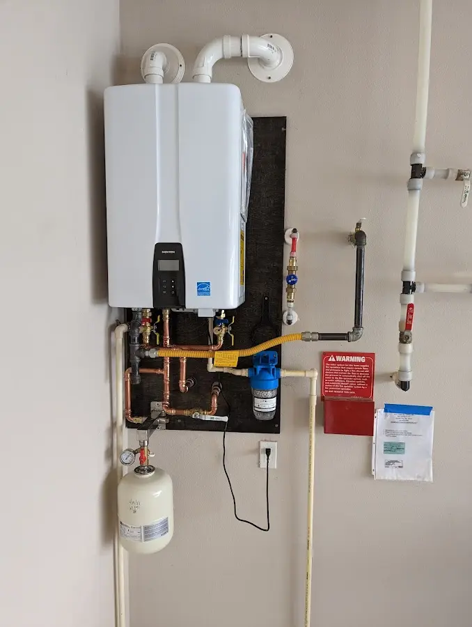 Professional plumber installing copper piping in a Hayes home